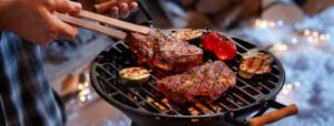 man cooking bbq for family